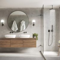 Salle de bain contemporaine moderne en béton gris avec miroir rond