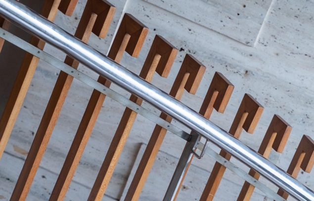 Close-up diagonal view of a modern wood and stainless steel stai